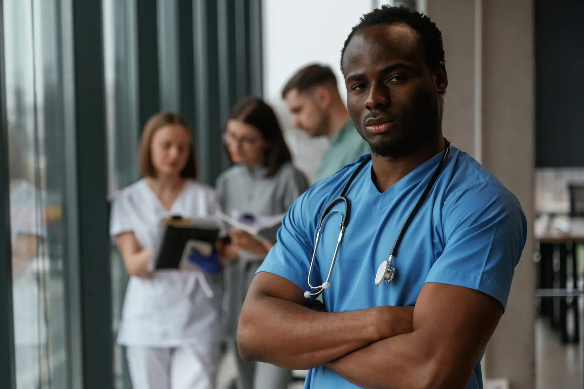 African American man is standing in front of colleagues