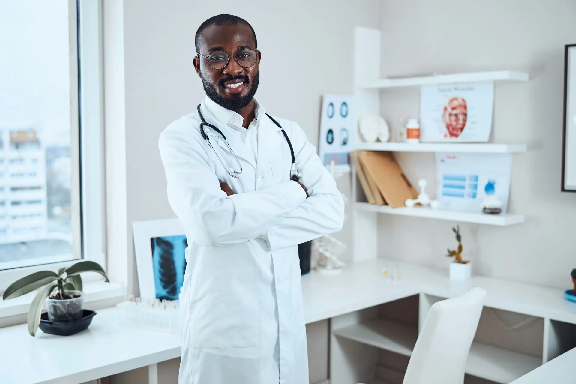 happy-doctor-staying-with-crossed-arms-in-an-offic-2026-03-24-08-54-39-utc